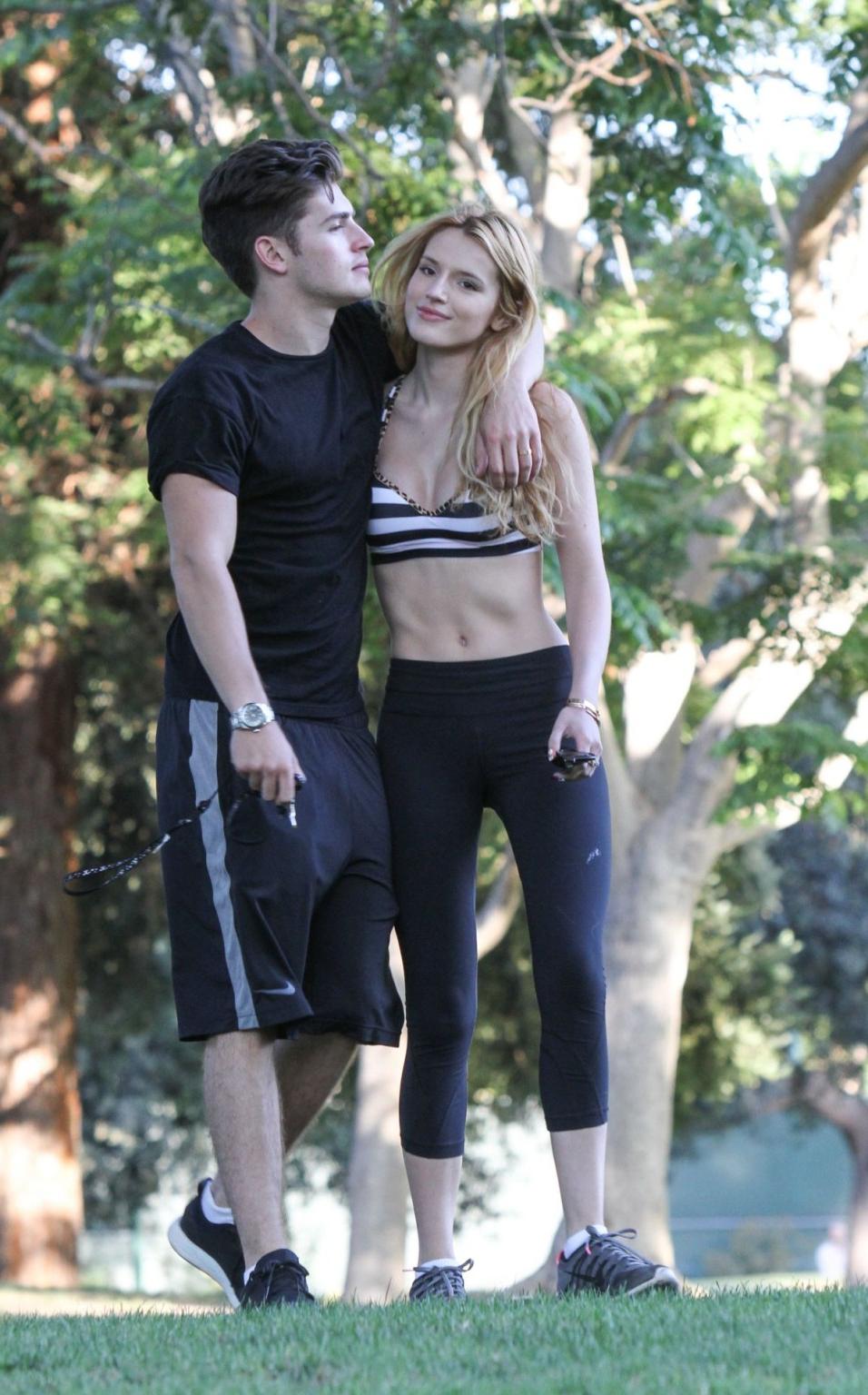 16P Bella Thorne busty in a striped sports bra and tights