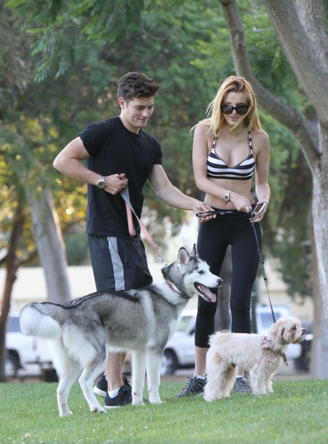16P Bella Thorne busty in a striped sports bra and tights
