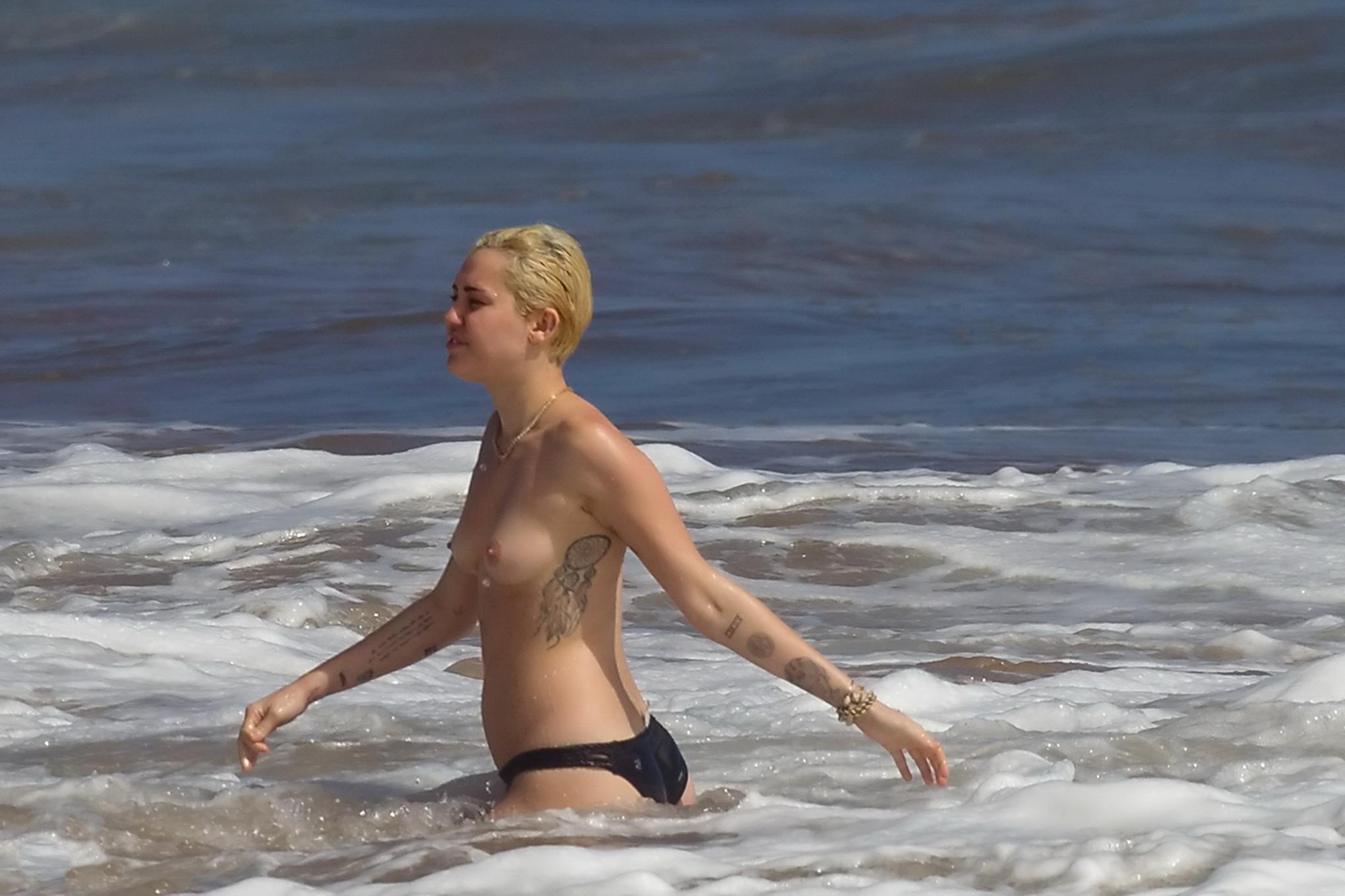 16P Miley Cyrus caught topless at the beach during the vacation in Hawaii