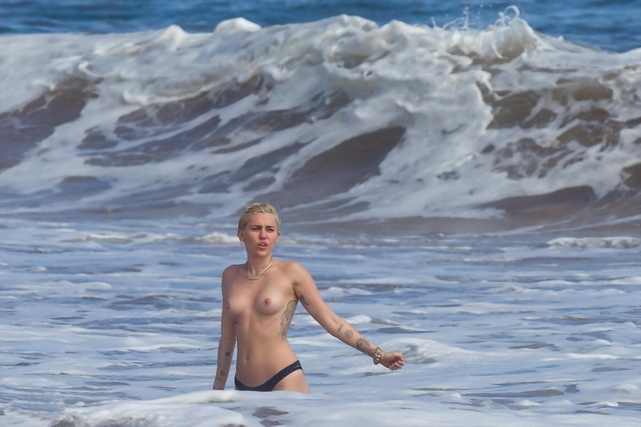 16P Miley Cyrus caught topless at the beach during the vacation in Hawaii