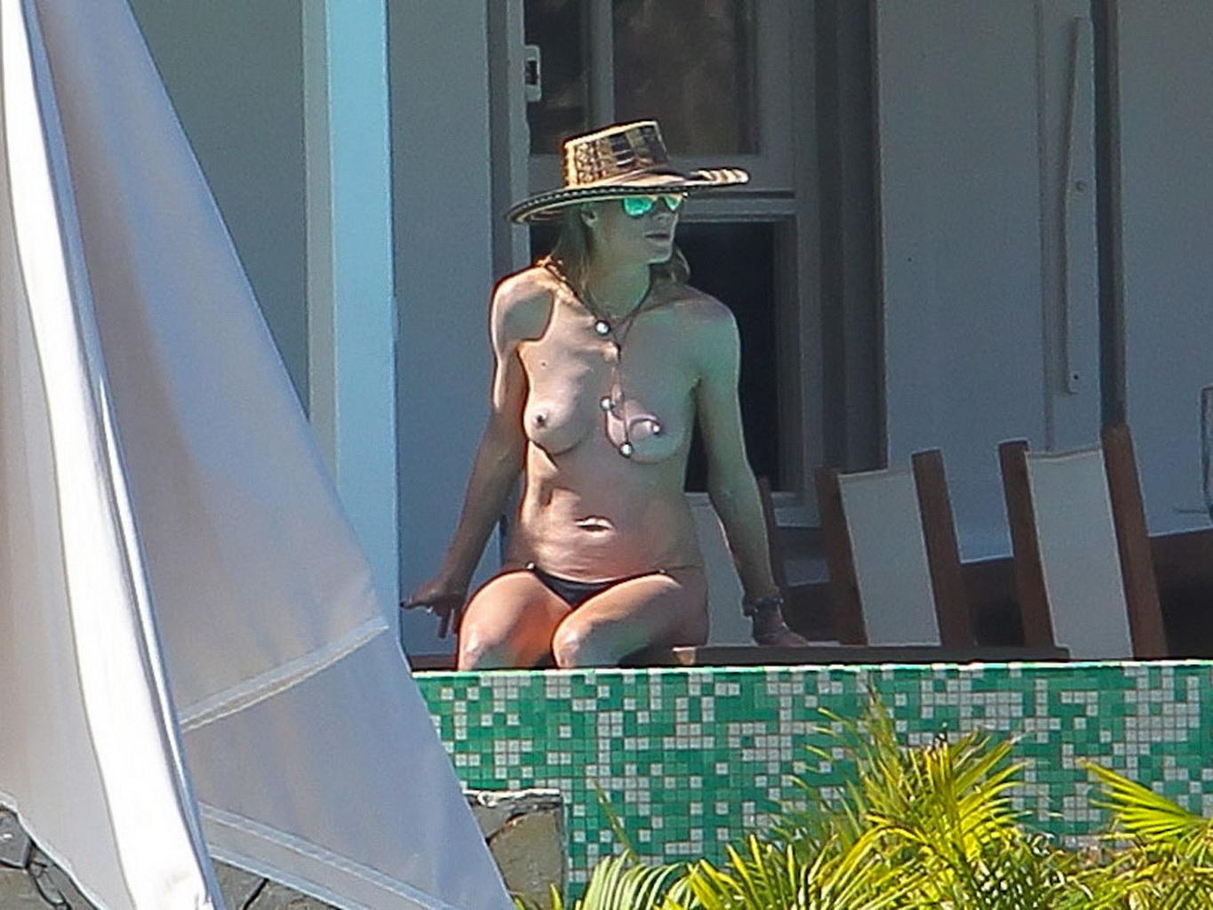 16P Heidi Klum caught topless wearing only black panties while on vacation in StBart