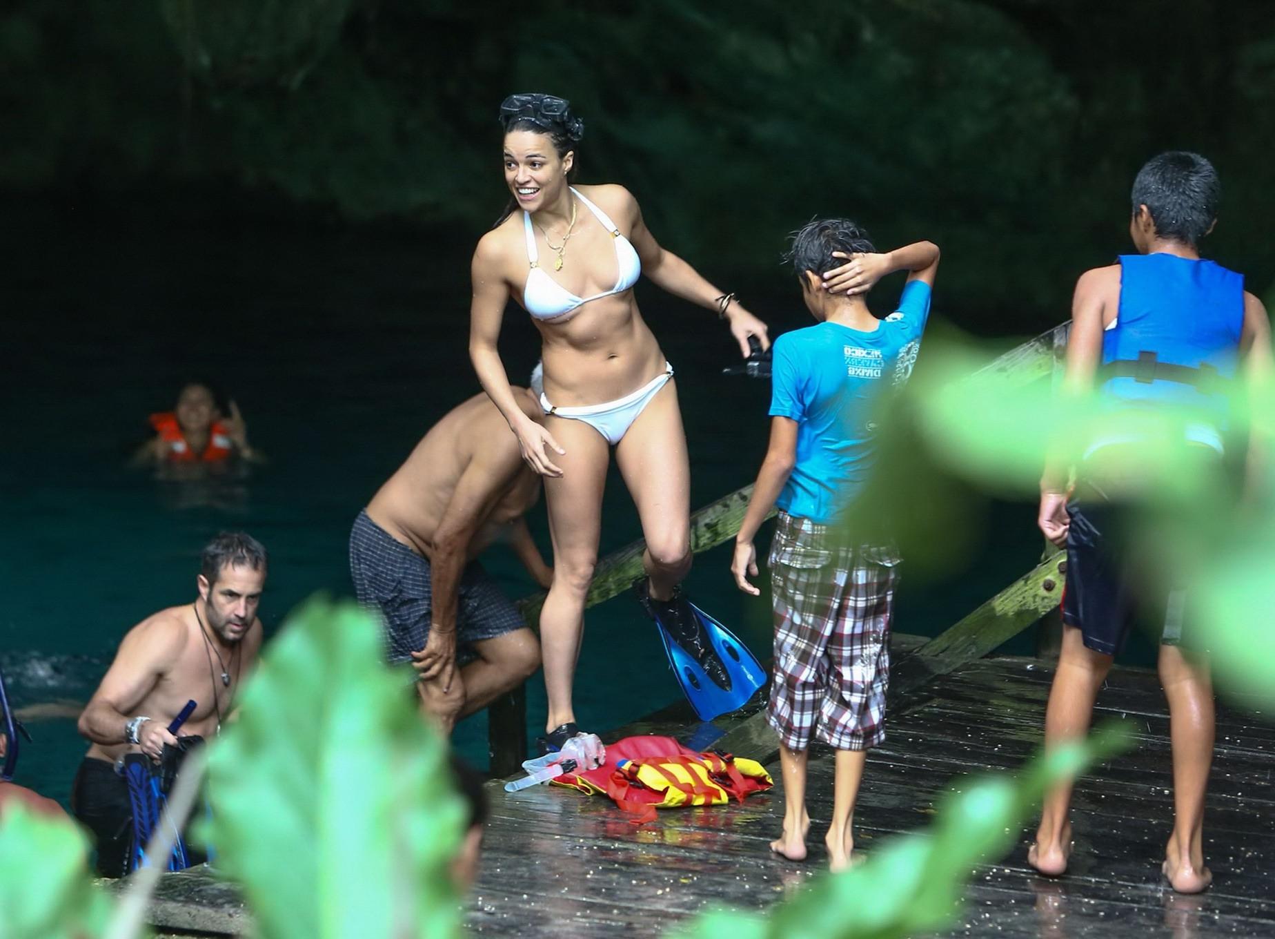 16P Michelle Rodriguez showing underboob and ass crack in white bikini at the beach 