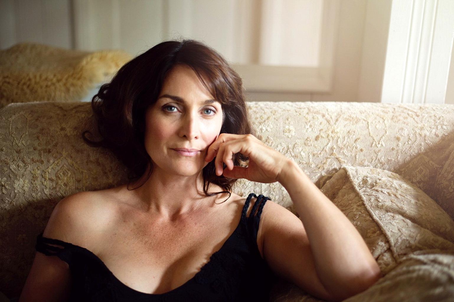 16P Busty CarrieAnne Moss wearing a low cut black dress in Catherine Just Photoshoot