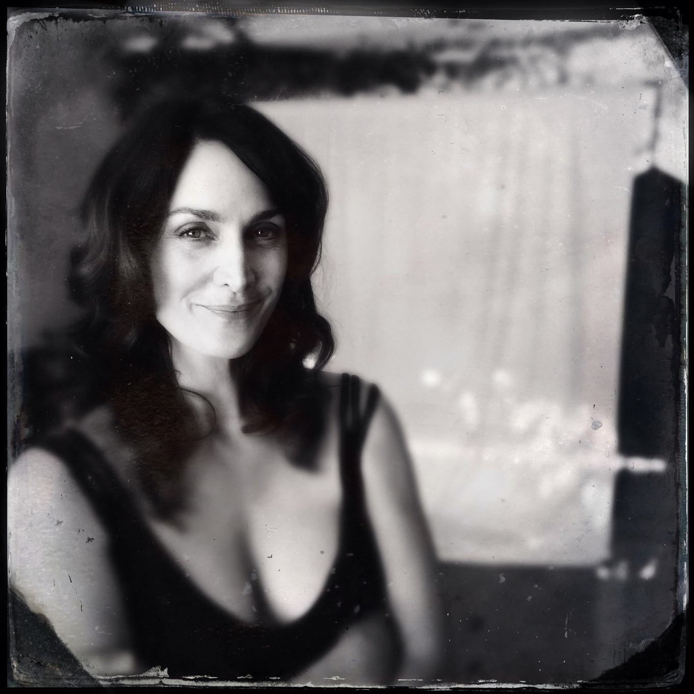 16P Busty CarrieAnne Moss wearing a low cut black dress in Catherine Just Photoshoot