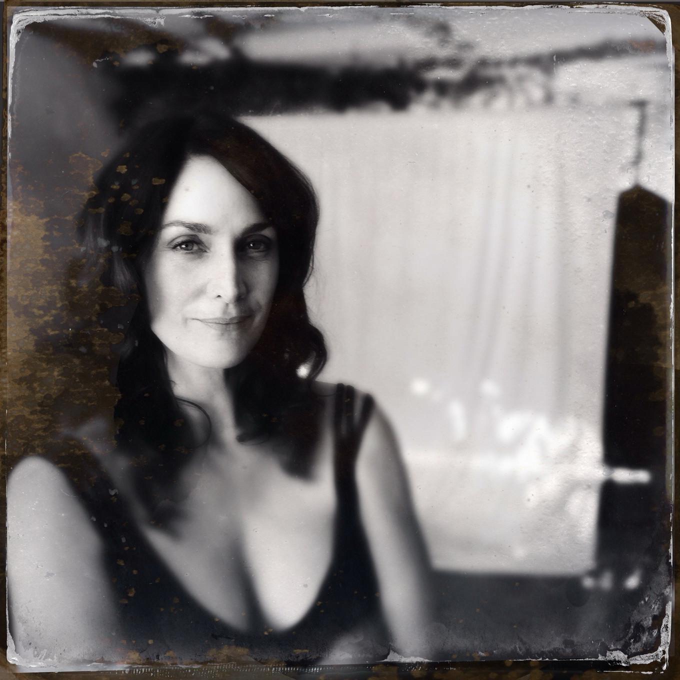 16P Busty CarrieAnne Moss wearing a low cut black dress in Catherine Just Photoshoot