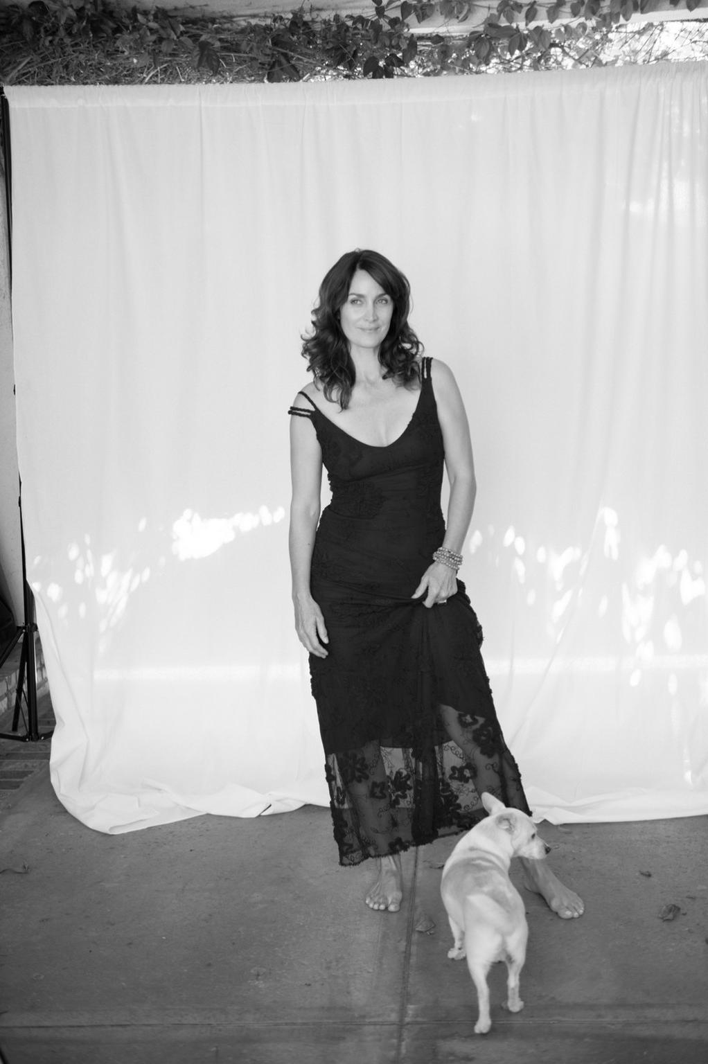 16P Busty CarrieAnne Moss wearing a low cut black dress in Catherine Just Photoshoot