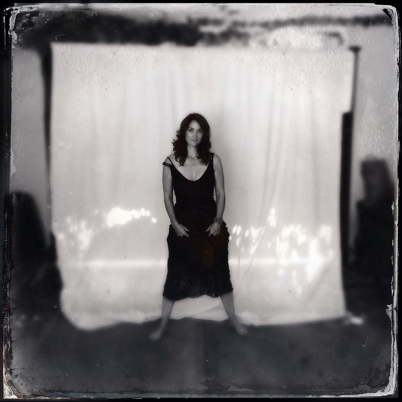 16P Busty CarrieAnne Moss wearing a low cut black dress in Catherine Just Photoshoot