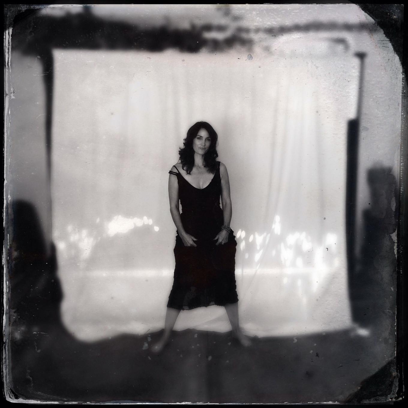 16P Busty CarrieAnne Moss wearing a low cut black dress in Catherine Just Photoshoot