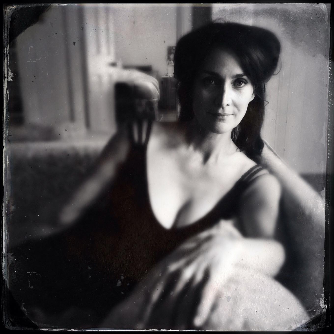 16P Busty CarrieAnne Moss wearing a low cut black dress in Catherine Just Photoshoot