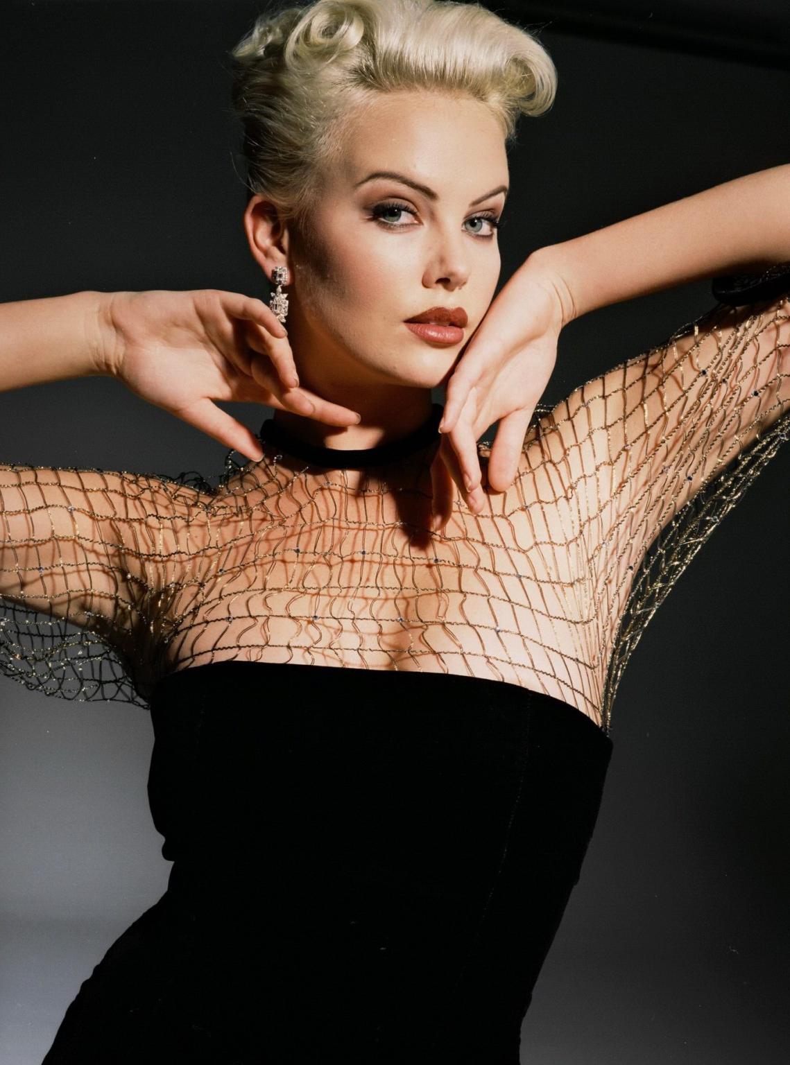 10P Charlize Theron hot wardrobe malfunction during the photoshoot by Nino Via