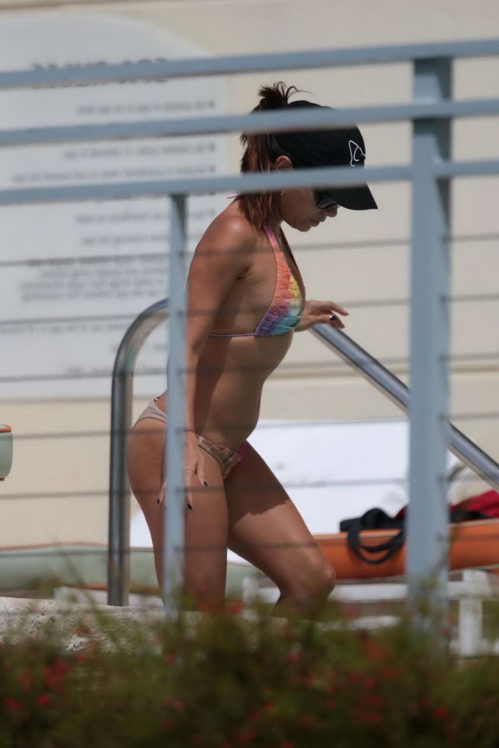 12P Eva Longoria caught in a tiny colorful bikini poolside in Miami