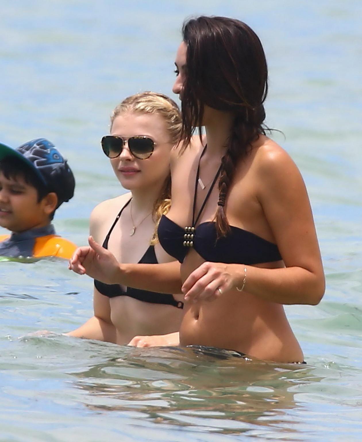 16P Chloe Moretz caught in a tiny black bikini at the beach in Miami