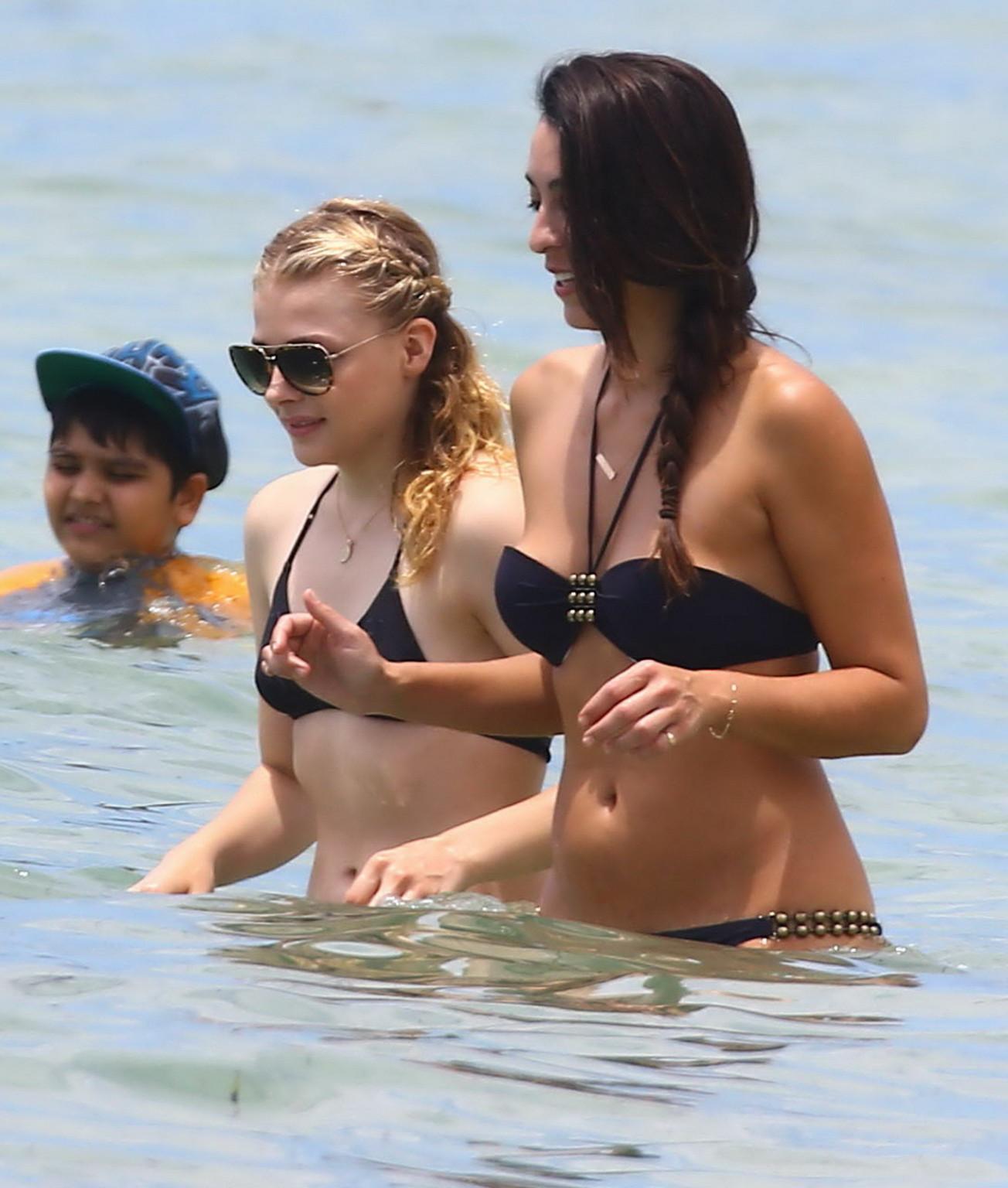 16P Chloe Moretz caught in a tiny black bikini at the beach in Miami