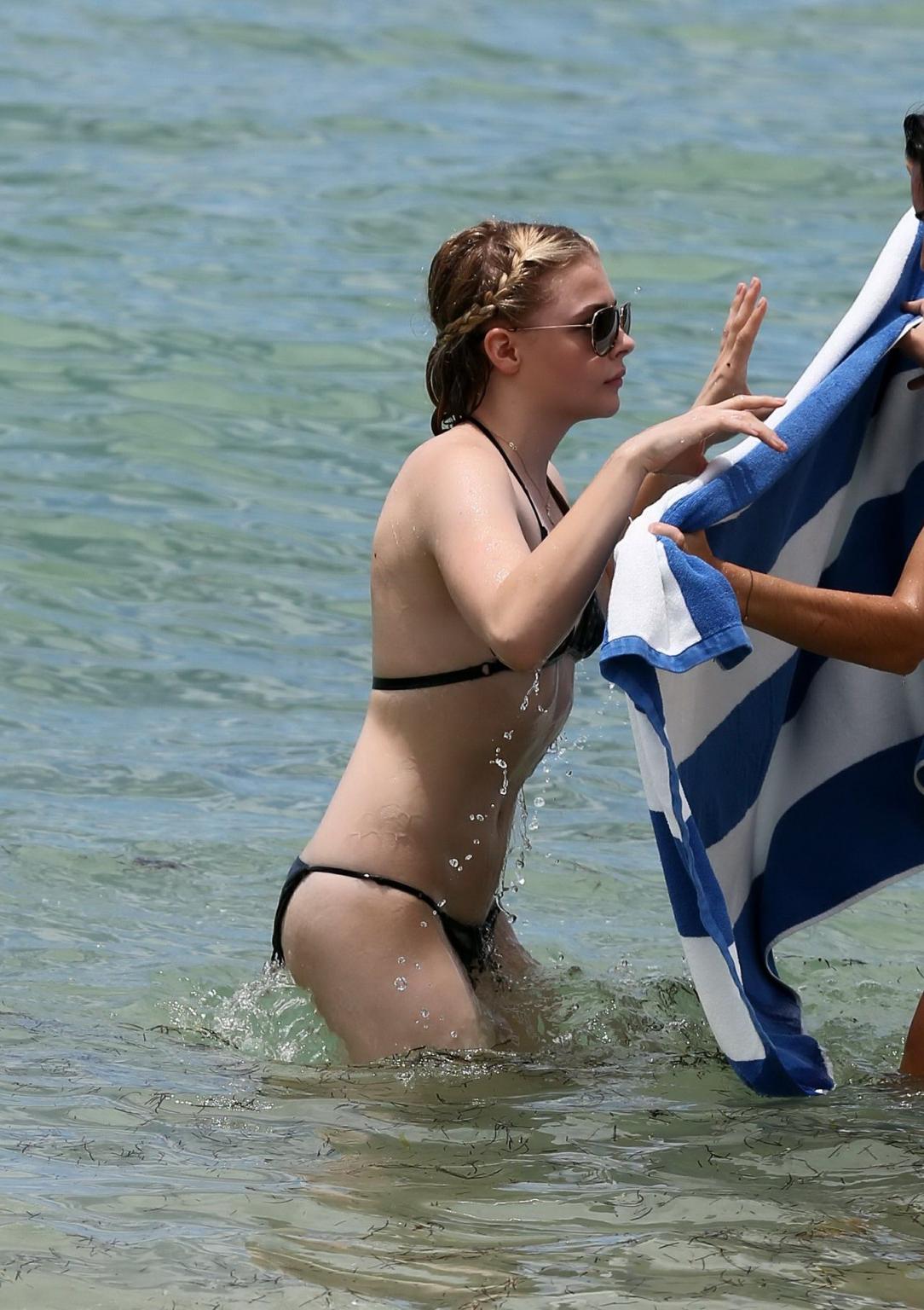 16P Chloe Moretz caught in a tiny black bikini at the beach in Miami