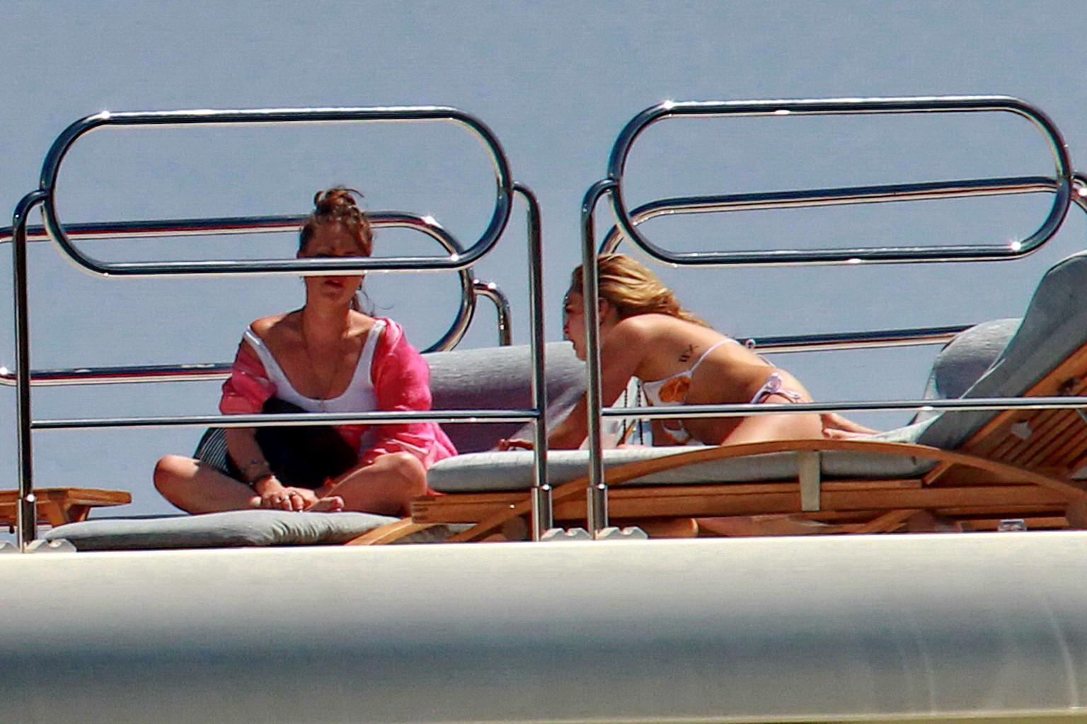 16P Cara Delevingne wearing a bikini on a yacht in Ibiza
