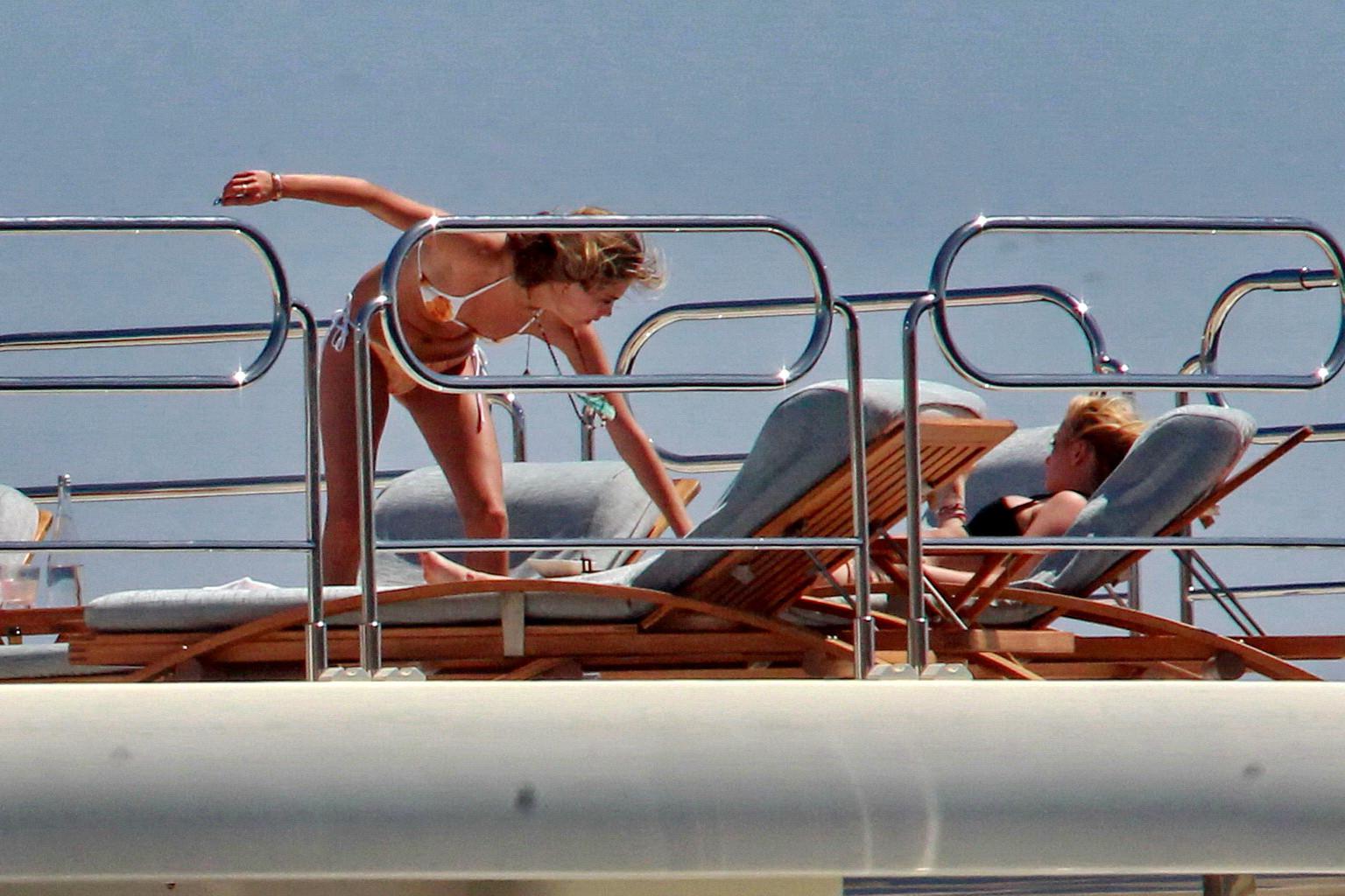 16P Cara Delevingne wearing a bikini on a yacht in Ibiza