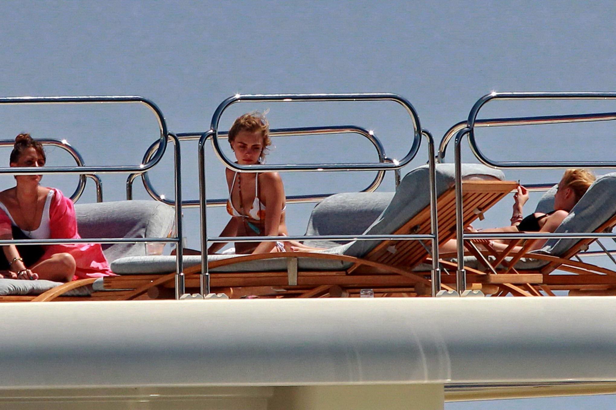 16P Cara Delevingne wearing a bikini on a yacht in Ibiza