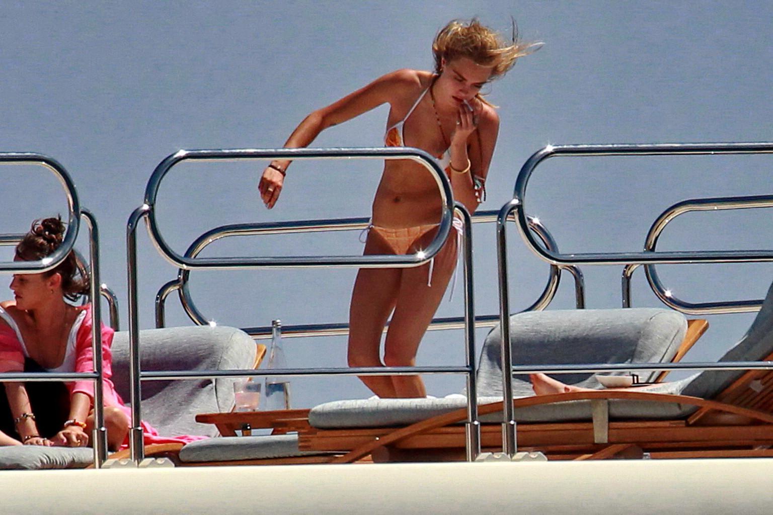 16P Cara Delevingne wearing a bikini on a yacht in Ibiza