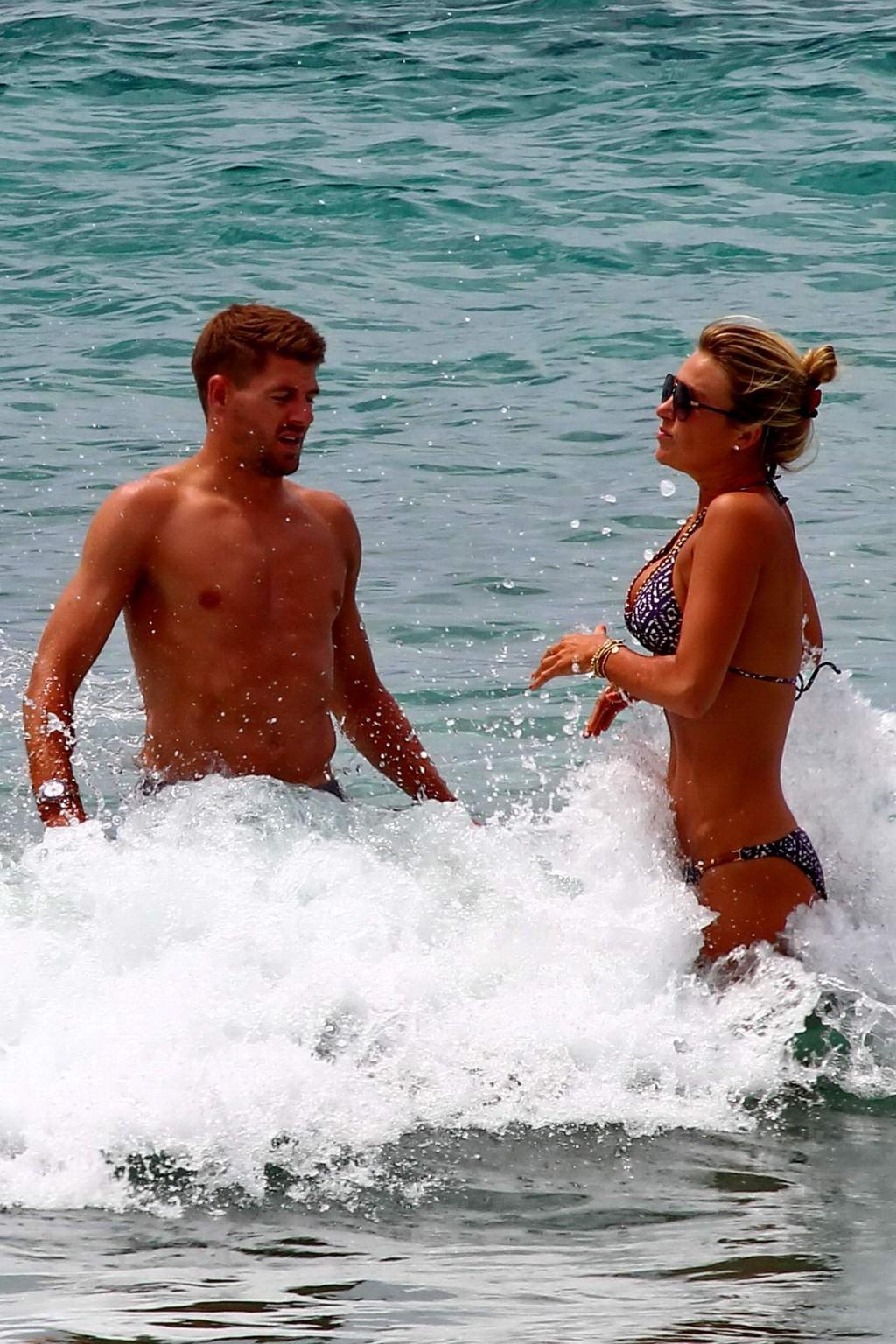 16P Busty Alex Gerrard wearing a bikini on a beach in Ibiza