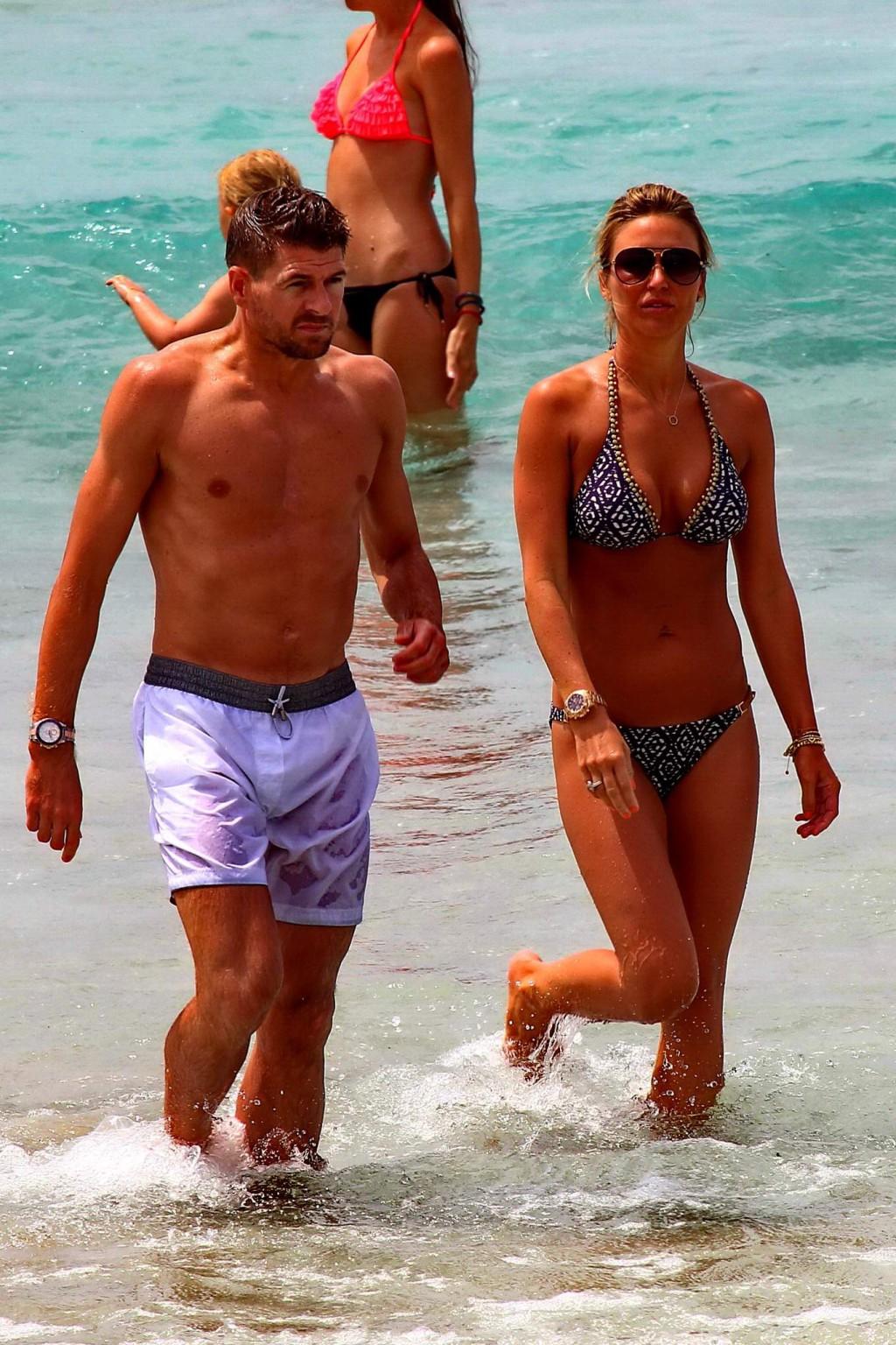 16P Busty Alex Gerrard wearing a bikini on a beach in Ibiza