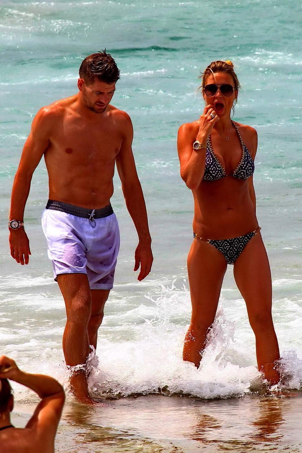 16P Busty Alex Gerrard wearing a bikini on a beach in Ibiza