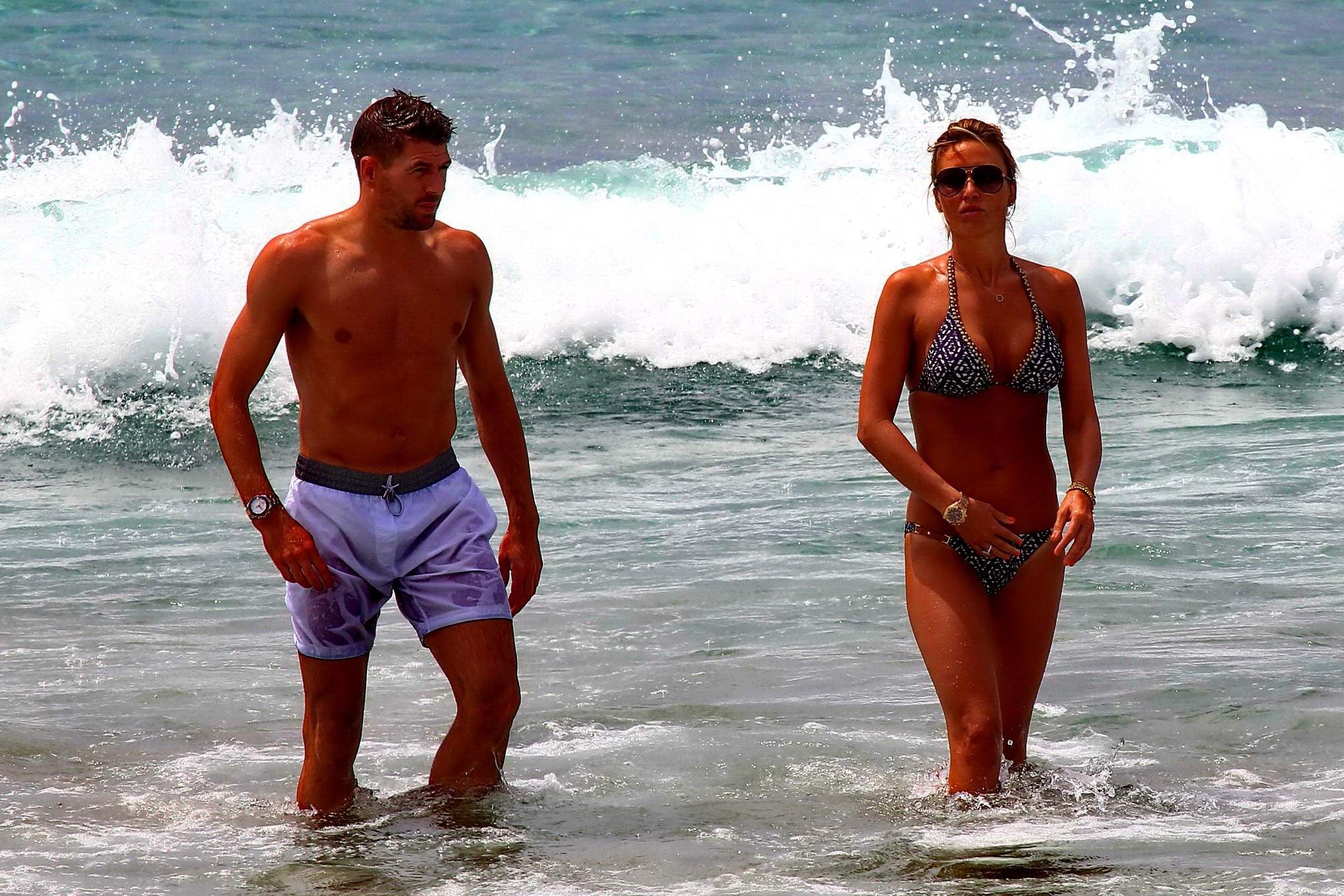 16P Busty Alex Gerrard wearing a bikini on a beach in Ibiza