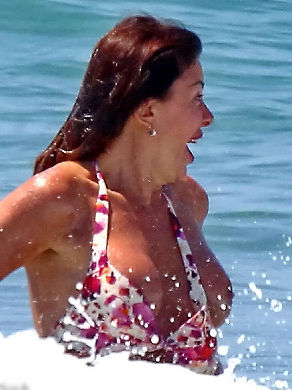 16P Alba Parietti topless showing off her big boobs on a beach in Ibiza