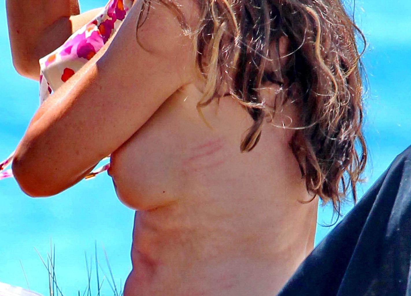 16P Alba Parietti topless showing off her big boobs on a beach in Ibiza