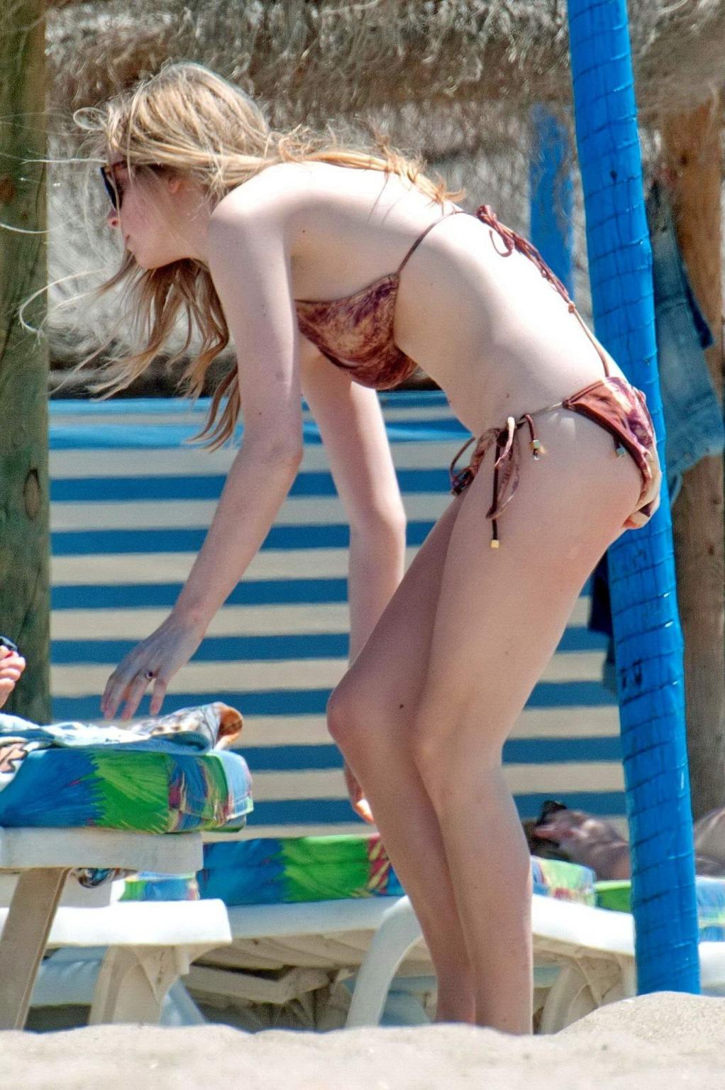 16P Diana Vickers wearing a wolf print bikini poolside in Spain