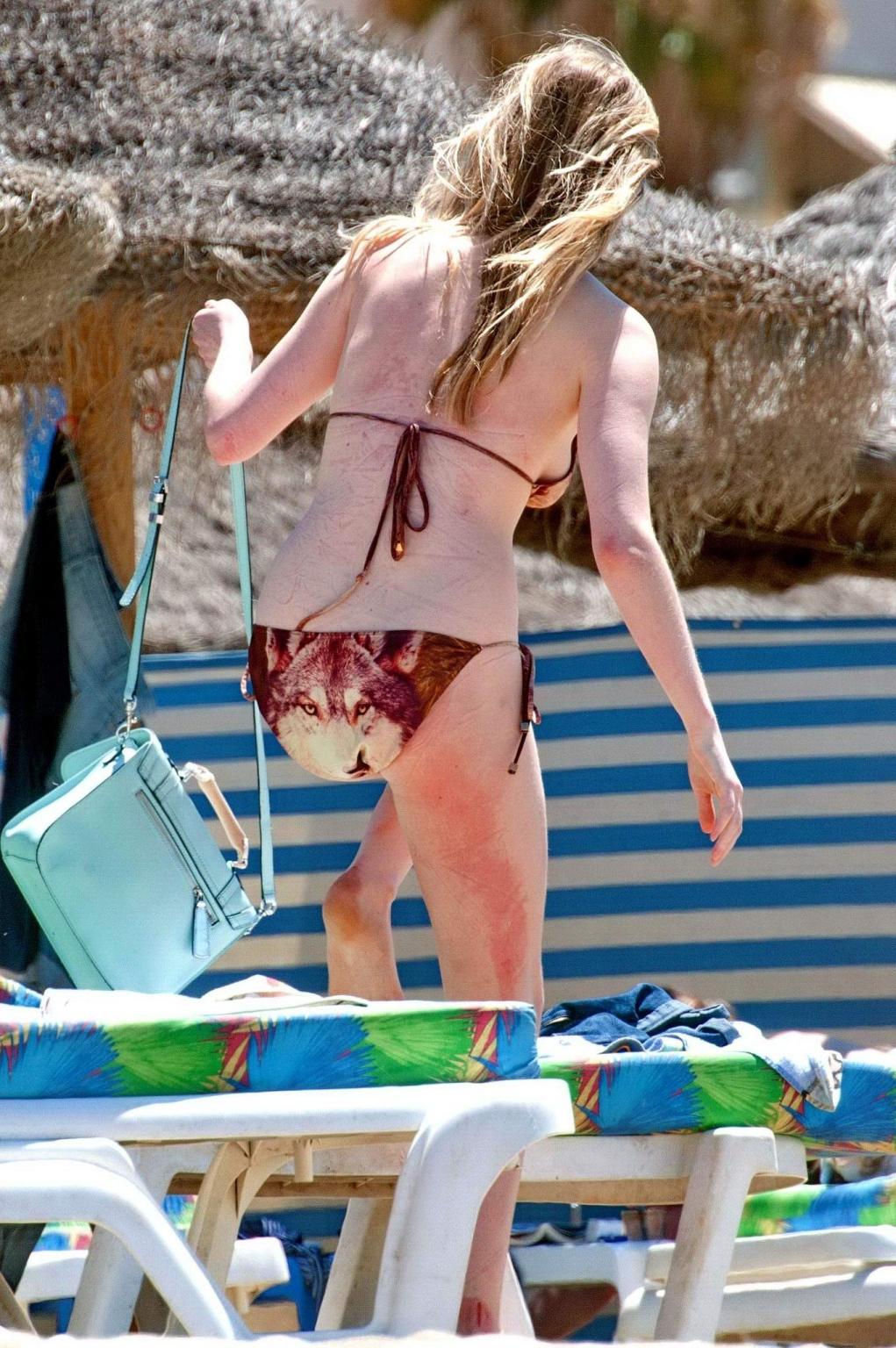 16P Diana Vickers wearing a wolf print bikini poolside in Spain