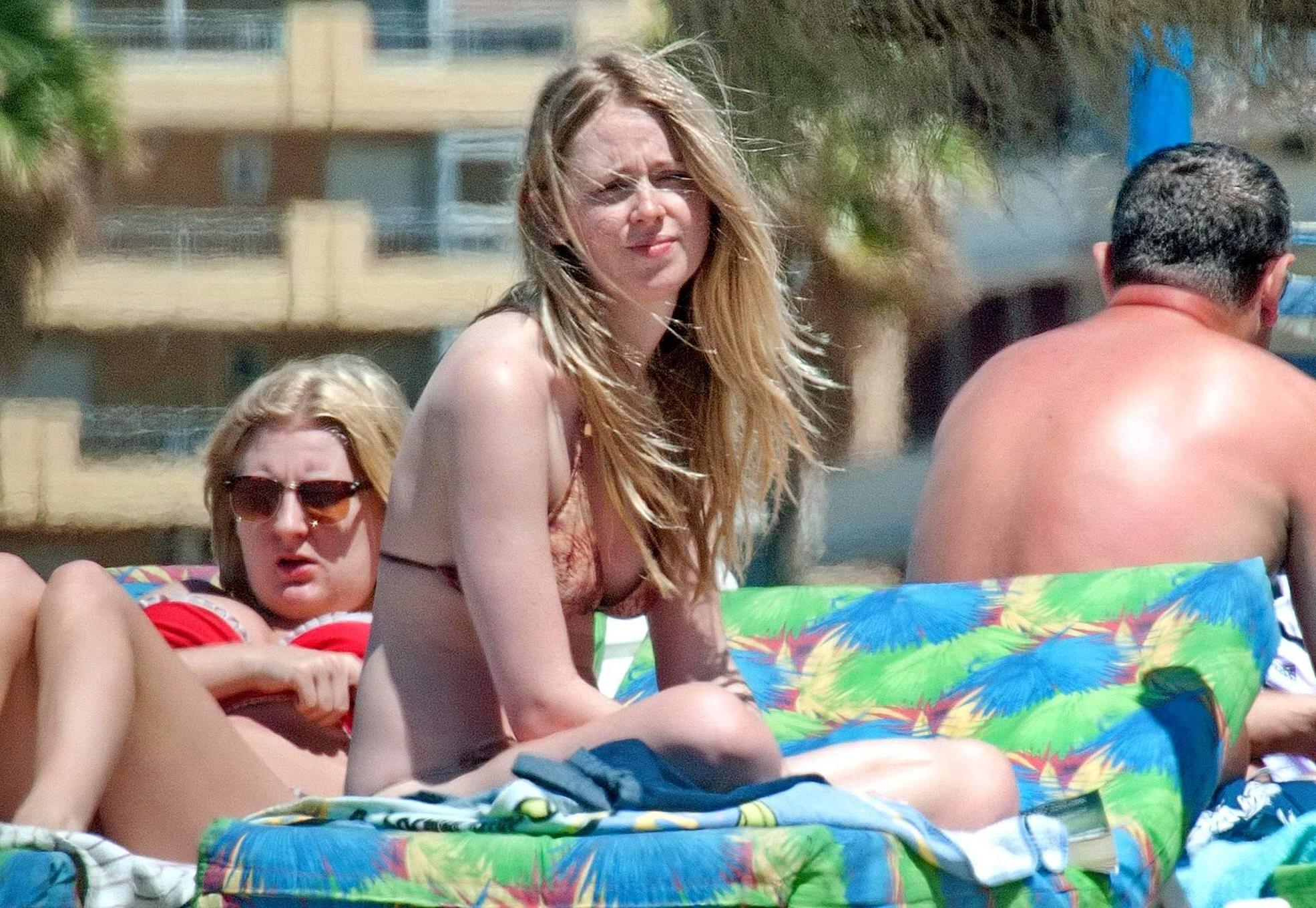 16P Diana Vickers wearing a wolf print bikini poolside in Spain