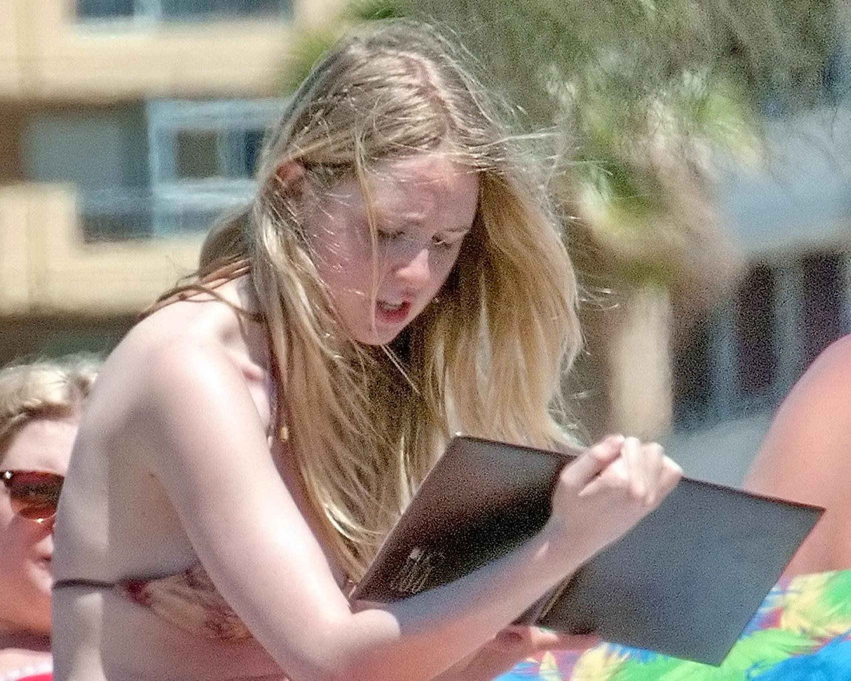 16P Diana Vickers wearing a wolf print bikini poolside in Spain
