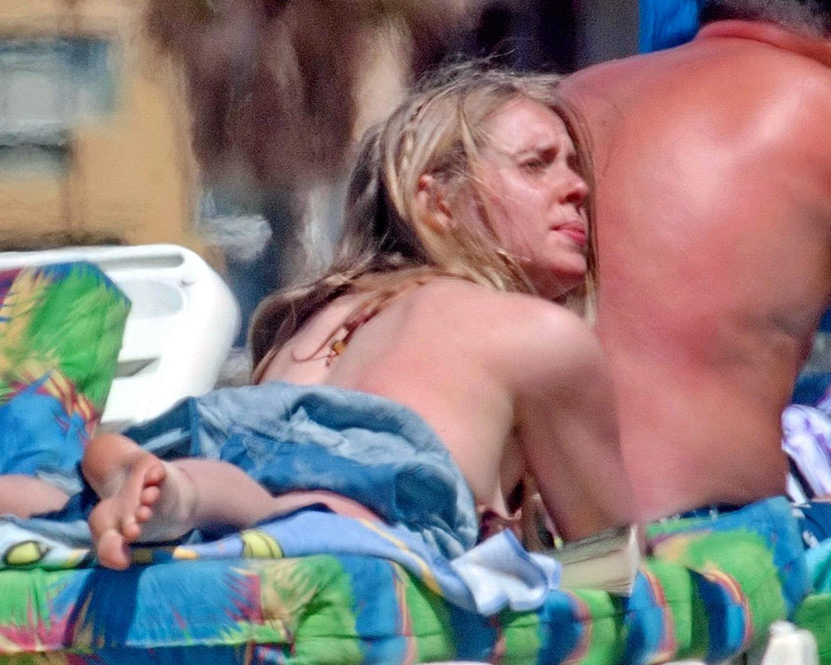 16P Diana Vickers wearing a wolf print bikini poolside in Spain