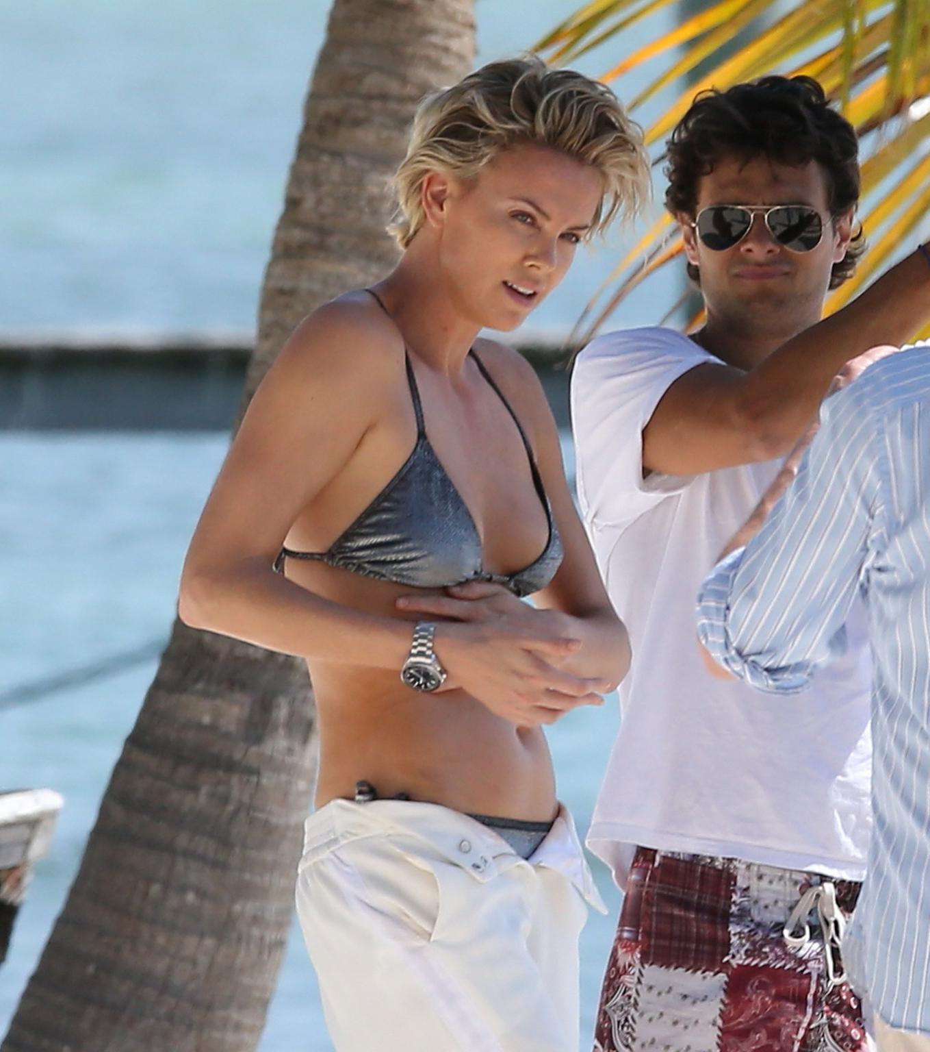 16P Charlize Theron showing off her hot bikini body while doing a sexy photoshoot in