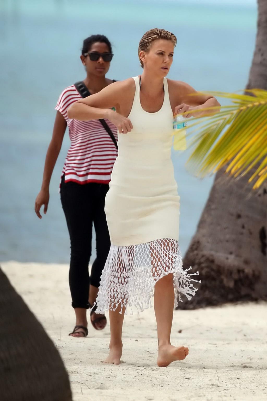 16P Charlize Theron showing off her hot bikini body while doing a sexy photoshoot in
