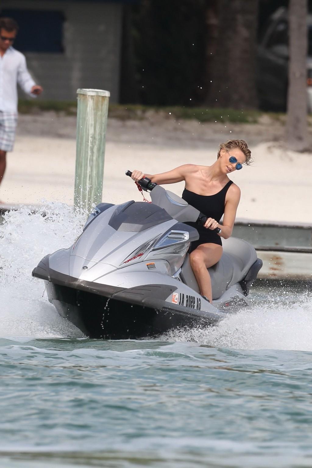 16P Charlize Theron jet skiing in black monokini during the photoshoot in Miami Beac