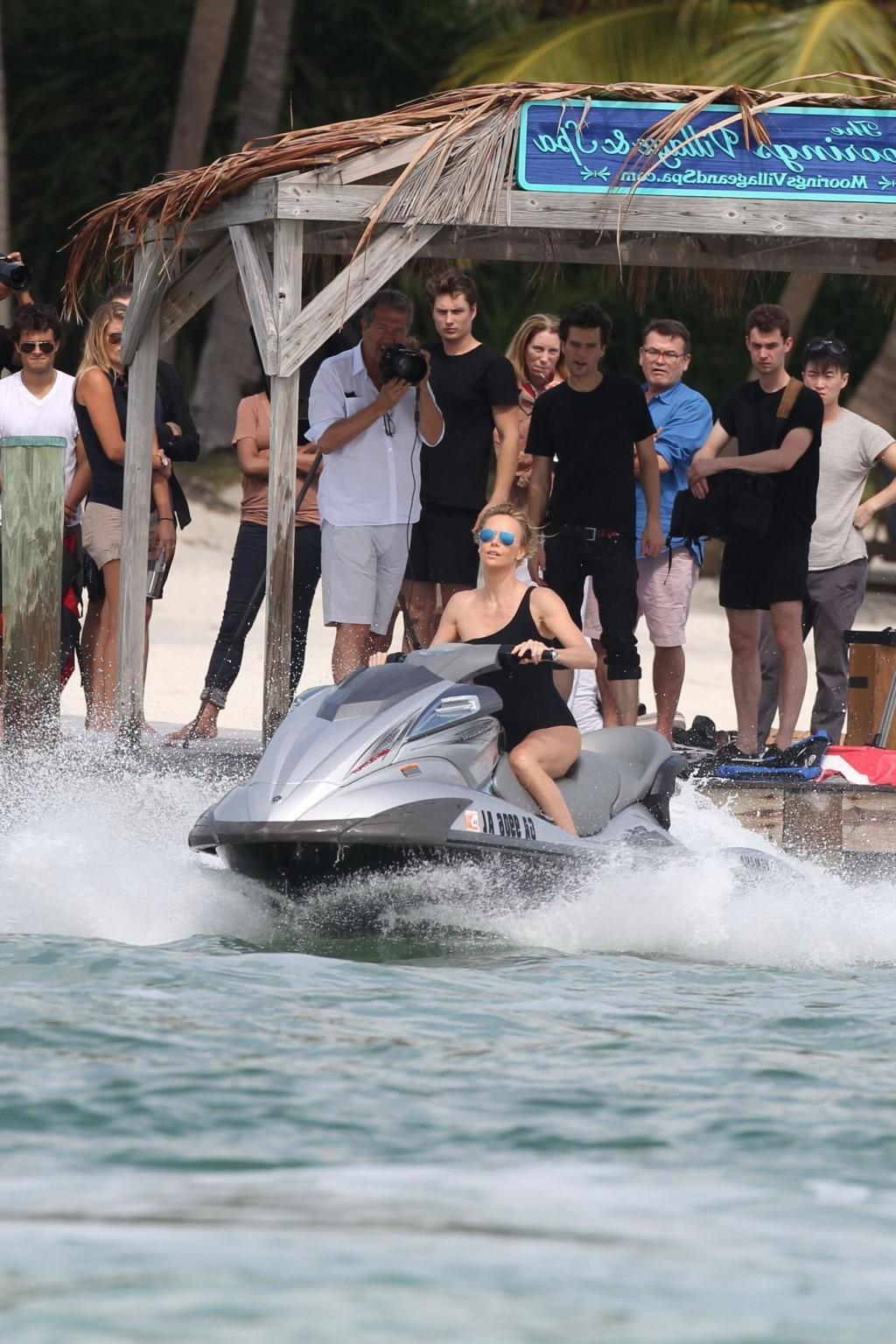 16P Charlize Theron jet skiing in black monokini during the photoshoot in Miami Beac