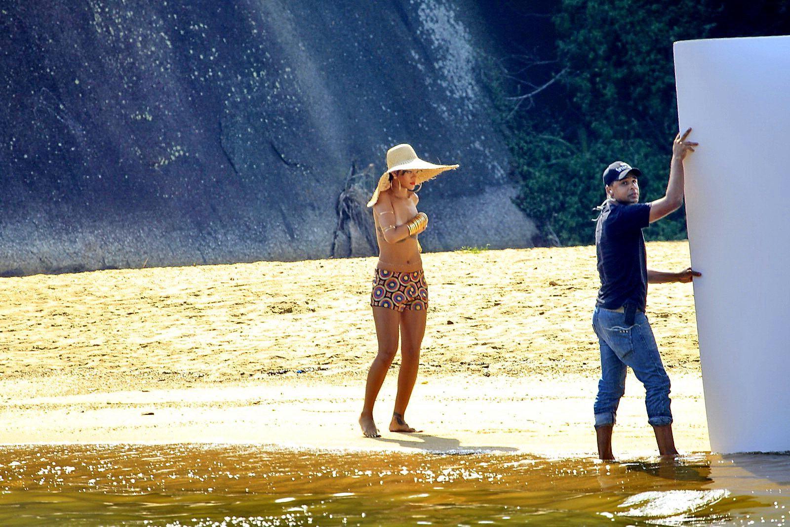 16P Rihanna showing off her boobs on the set of a photoshoot for Vogue Brasil in Ang