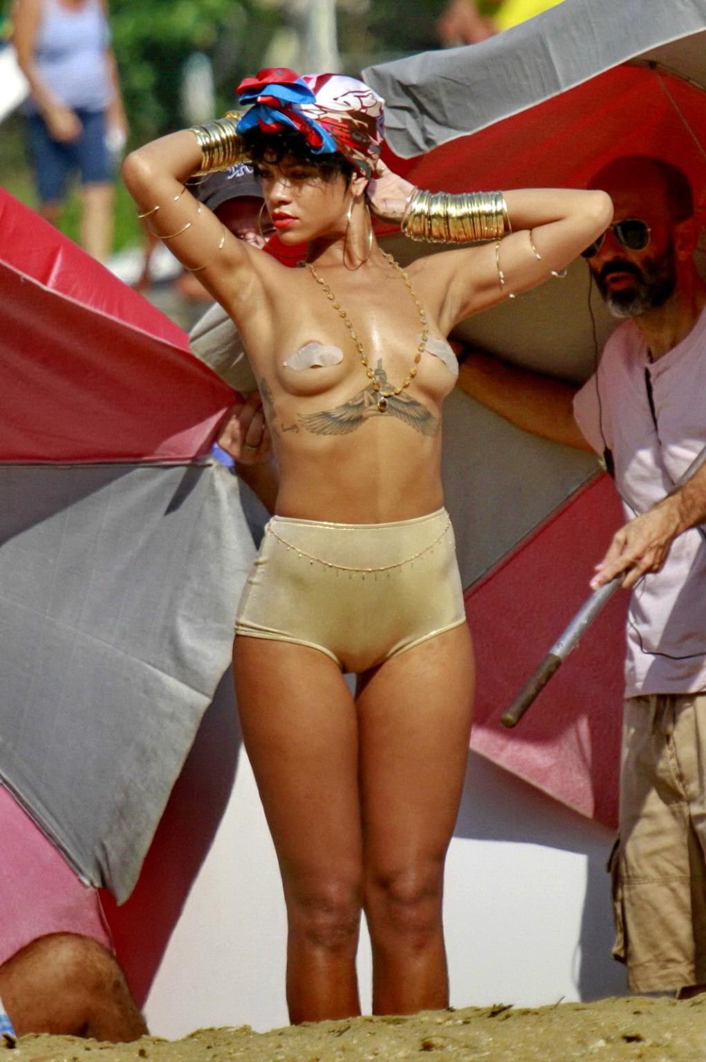 16P Rihanna showing off her boobs on the set of a photoshoot for Vogue Brasil in Ang