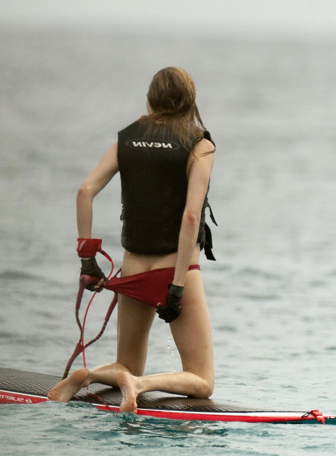 16P Cara Delevingne showing ass crack in red bikini at the beach in Barbados