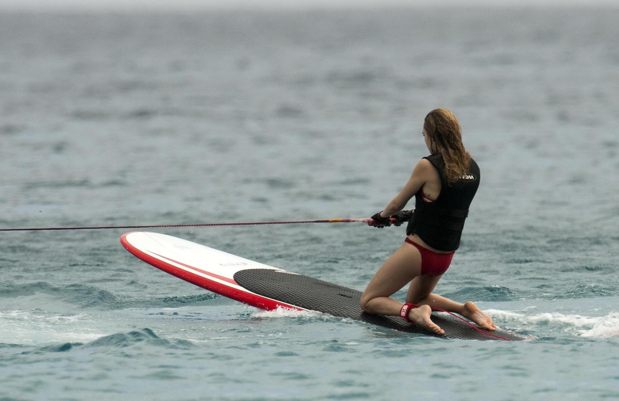 16P Cara Delevingne showing ass crack in red bikini at the beach in Barbados