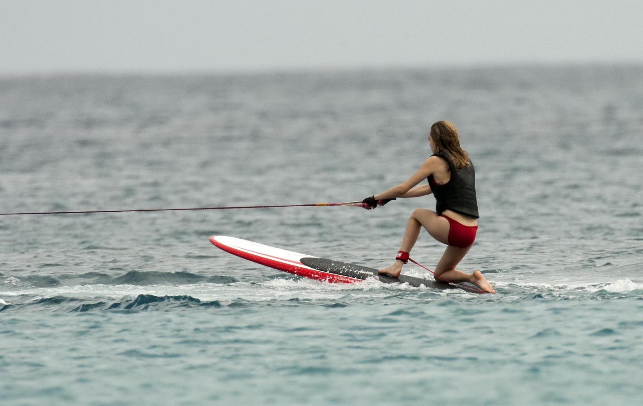 16P Cara Delevingne showing ass crack in red bikini at the beach in Barbados