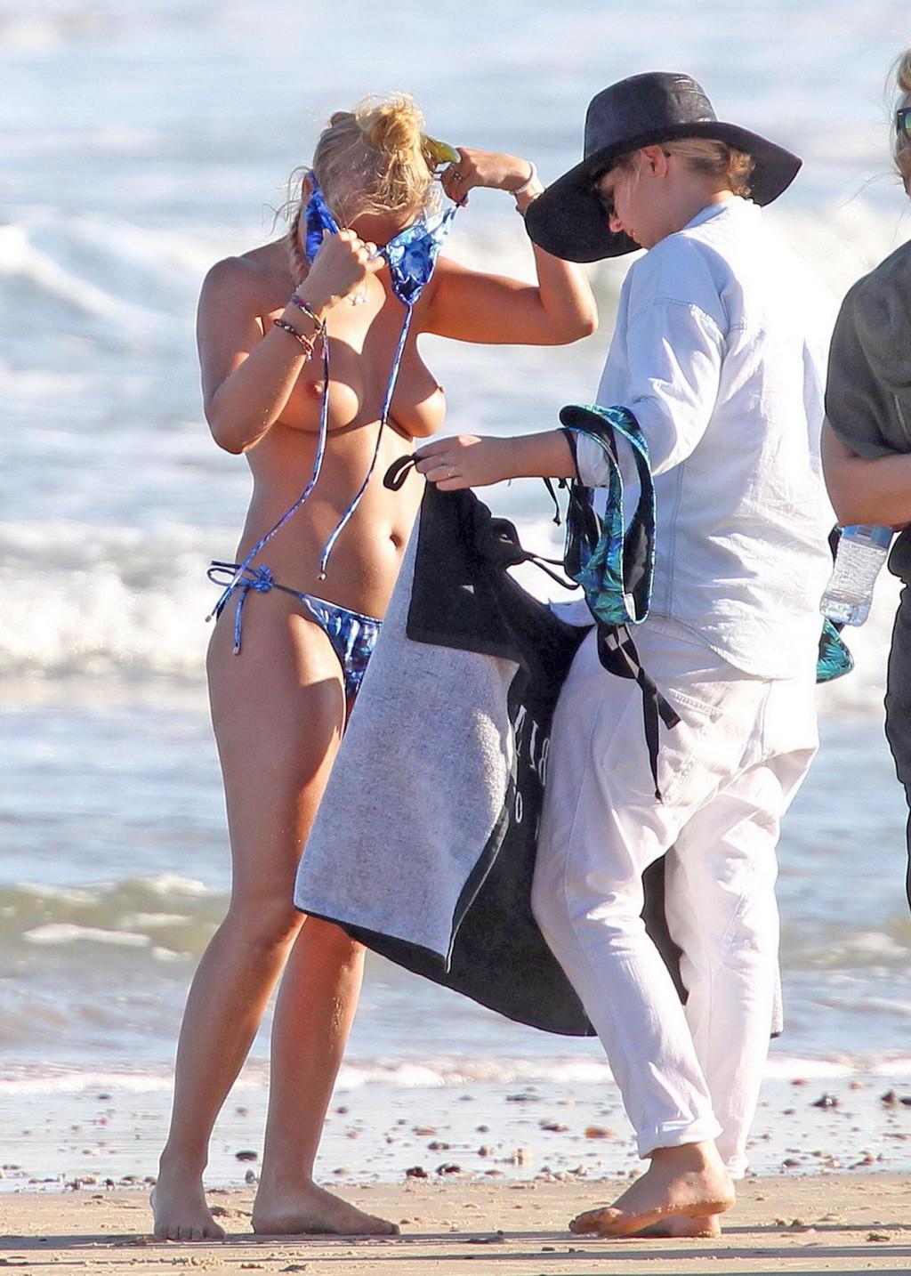 16P Lara Bingle showing off her big bare boobs during a bikini photoshoot at some be