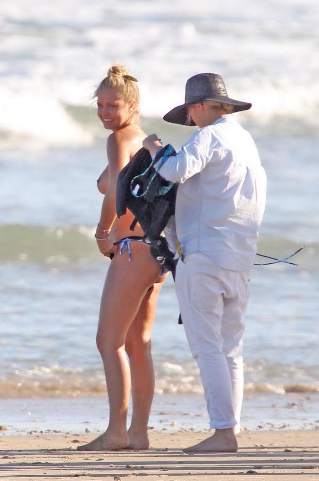 16P Lara Bingle showing off her big bare boobs during a bikini photoshoot at some be