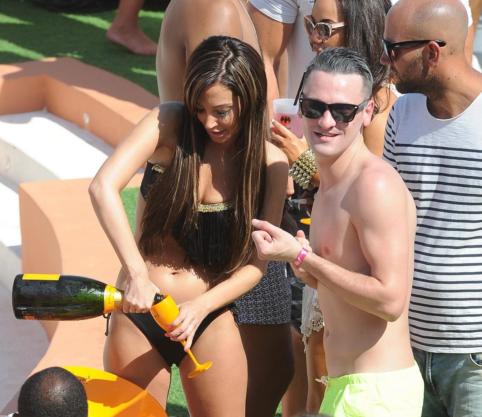 16P Tulisa Contostavlos wearing a strapless black bikini at the summer party in Ibiz