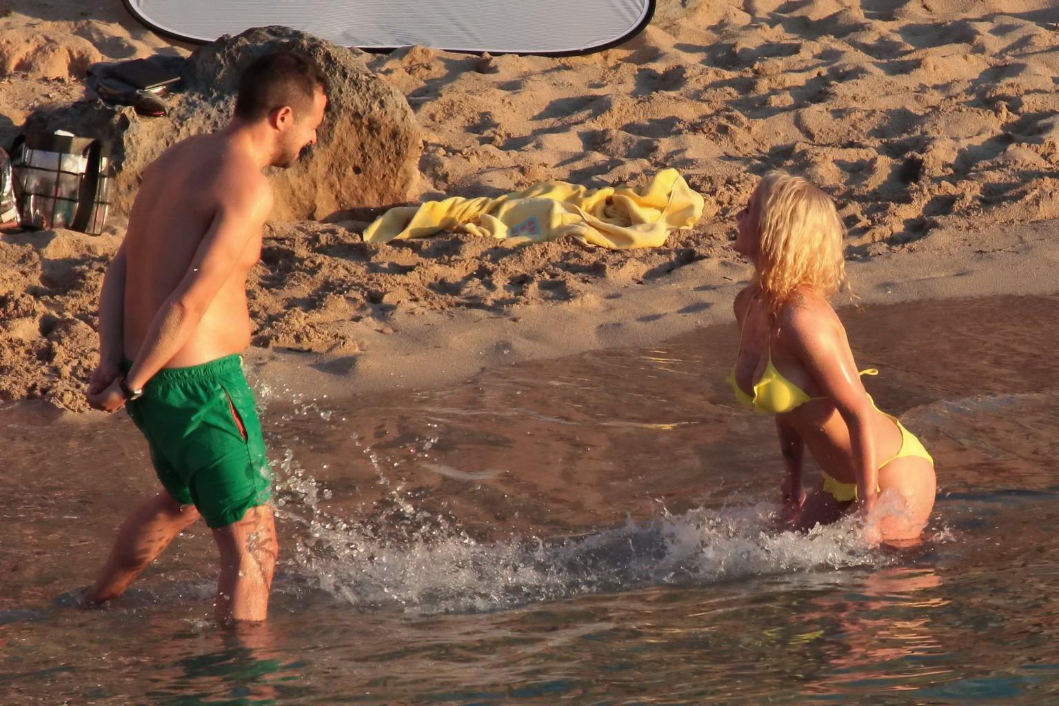 16P Helen Flanagan stripping her skimpy yellow bikini during photoshoot at the beach