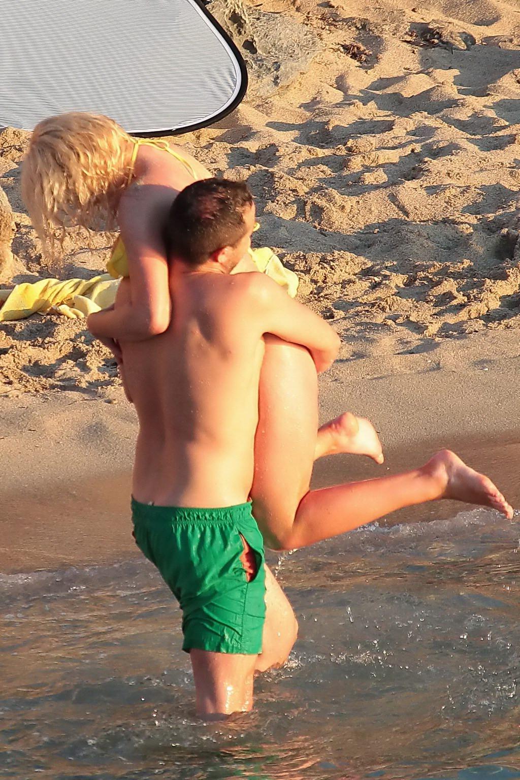 16P Helen Flanagan stripping her skimpy yellow bikini during photoshoot at the beach
