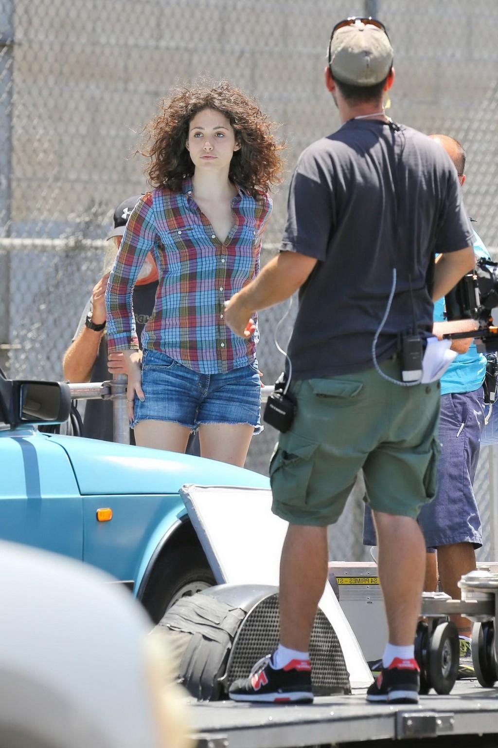 16P Emmy Rossum wearing denim shorts and some crazy hair on the set of Comet in LA