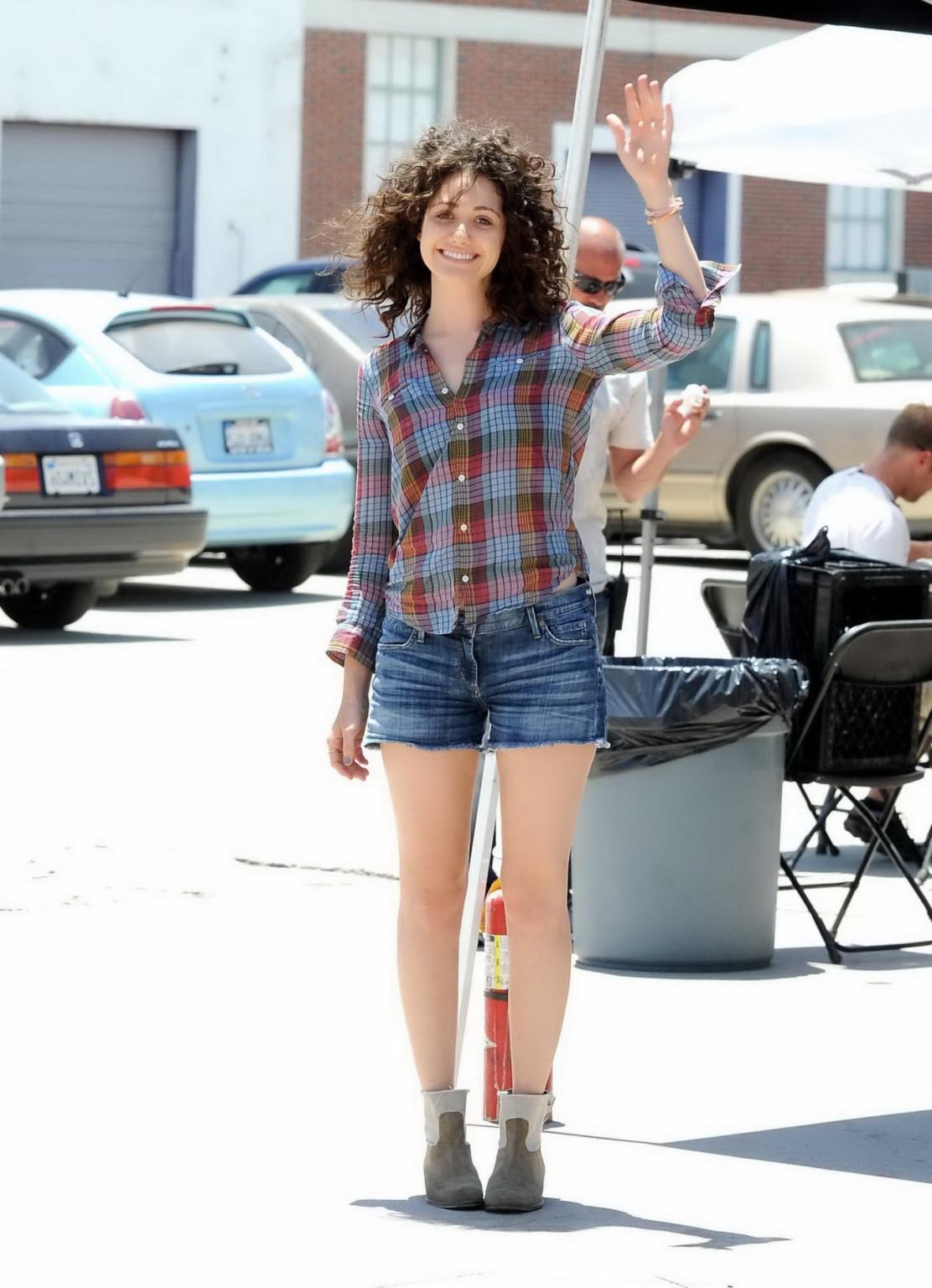 16P Emmy Rossum wearing denim shorts and some crazy hair on the set of Comet in LA