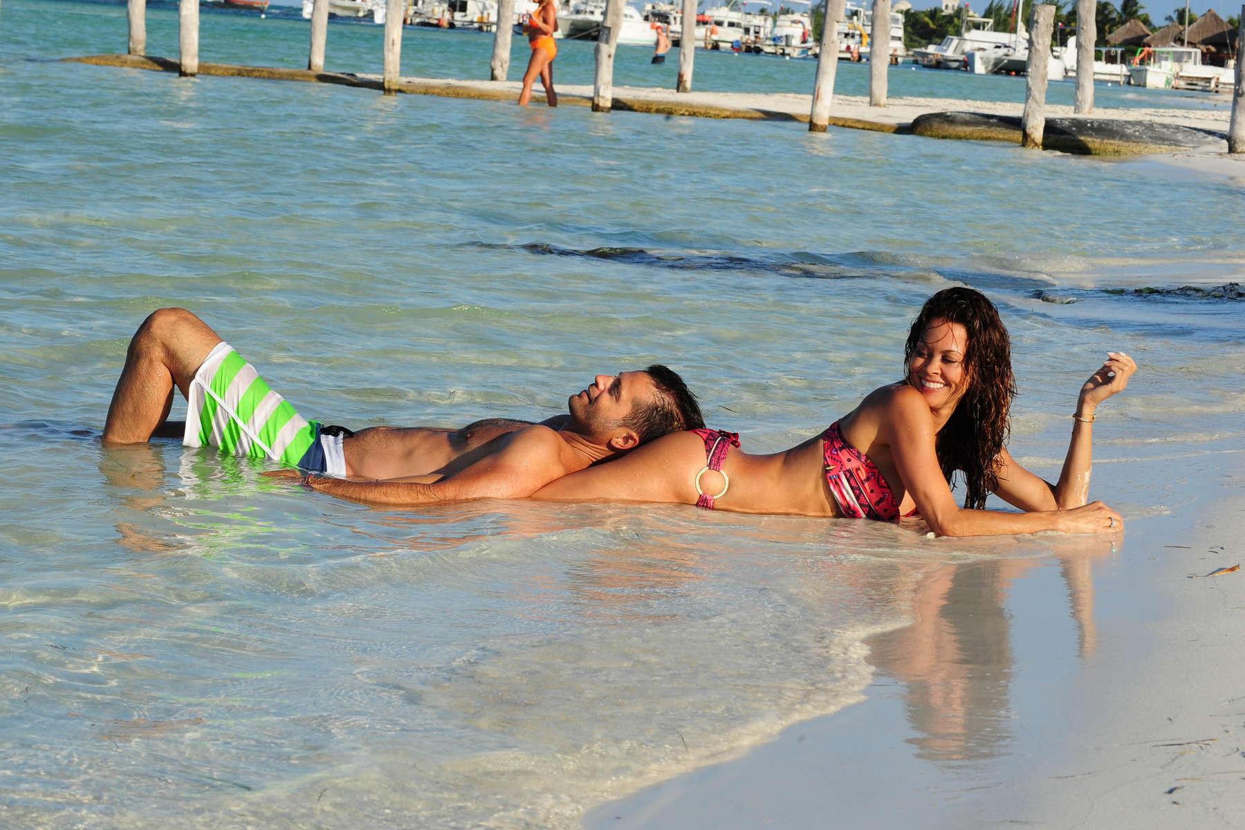16P Brooke Burke doing a bikini photoshoot on a beach in Mexico
